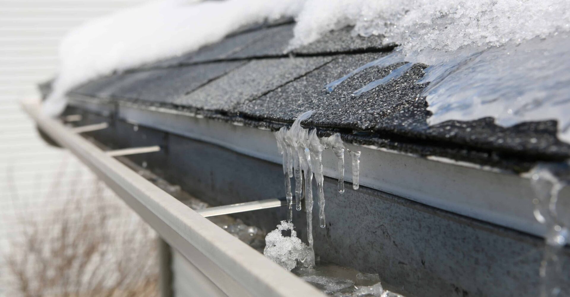 Close-up of metal roof seams on a house roof showing panel lines and fasteners